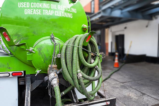 grease trap being pumped out by service technician in Biltmore Forest